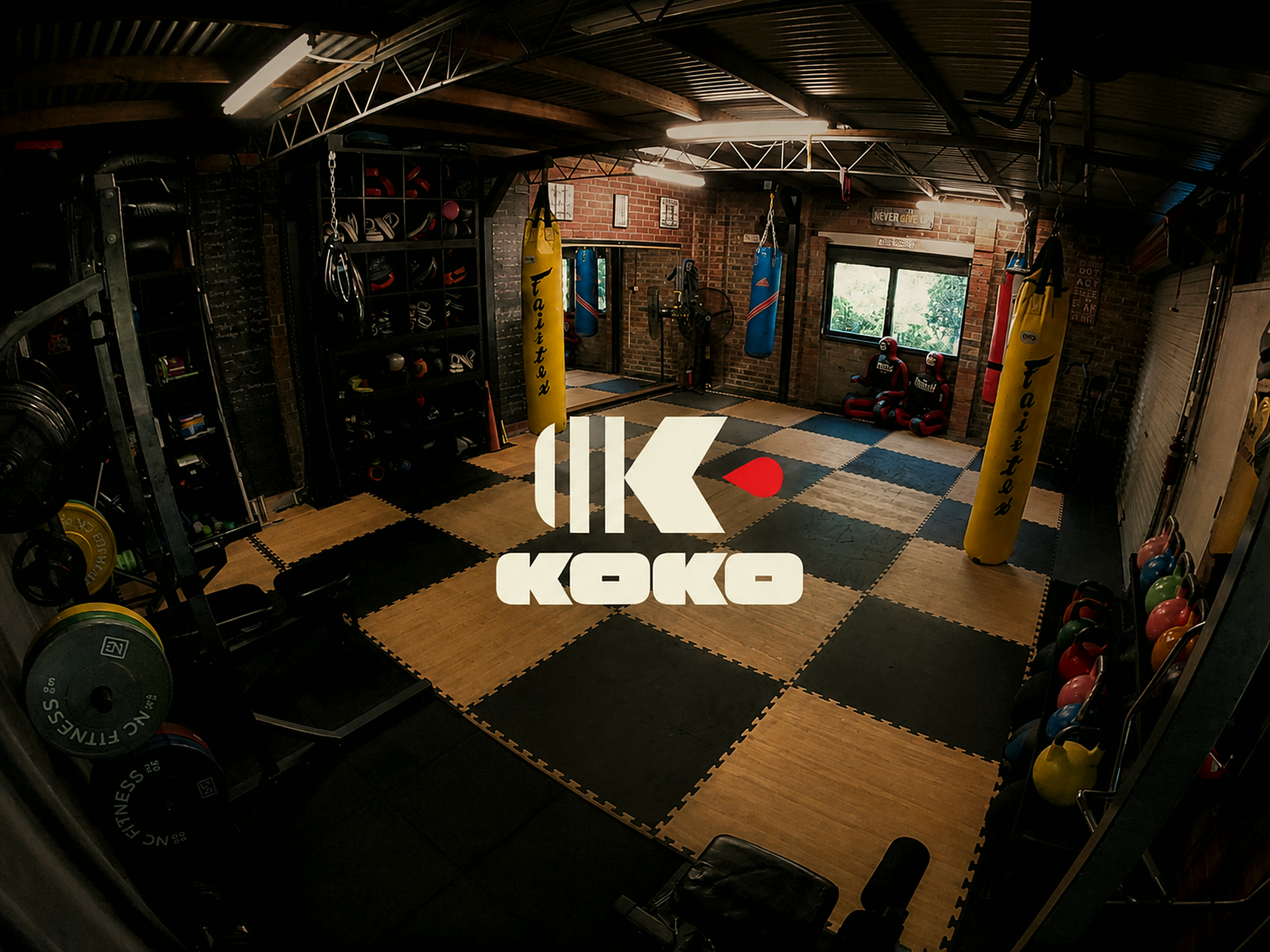 A garage gym kitted out for every art: mats, bags, and weights, ready to train